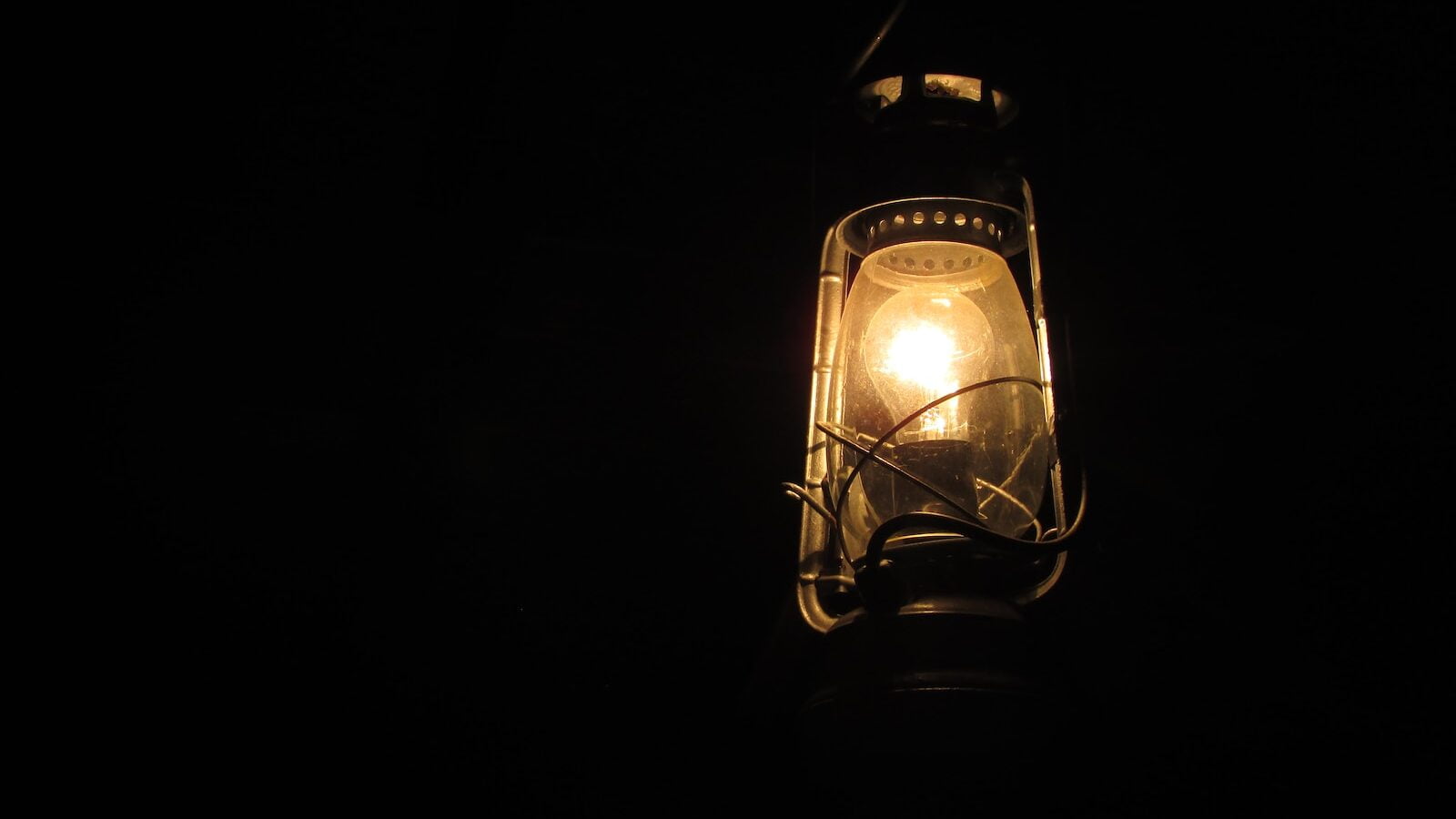 black and brown gas lantern turned on during nighttime